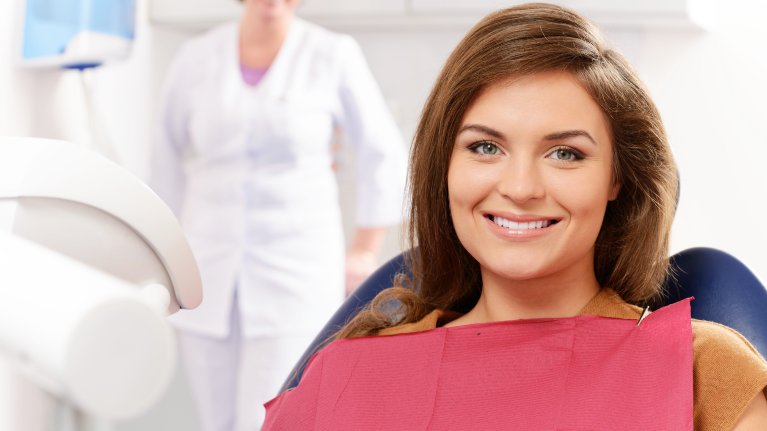 A Woman Sits In The Dental Chair